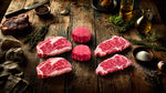Marbled Meatery Corporate steak gift package showcasing premium ribeye, filet, and strip steaks on wooden board, ideal for executive gifting and client appreciation.